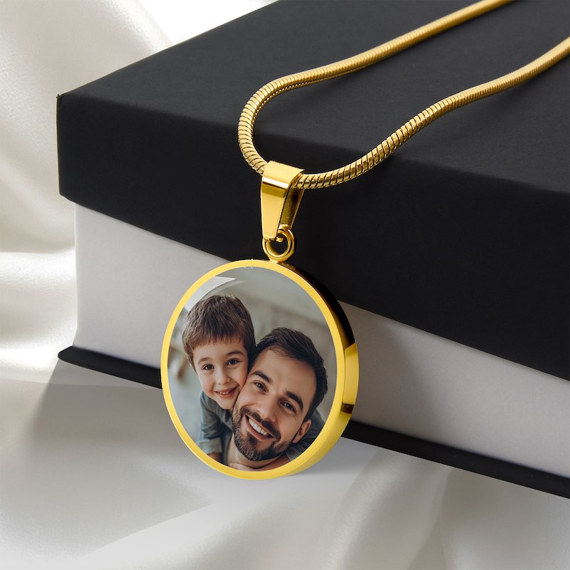 Personalized gold circle photo pendant necklace with father and son image displayed on gift box