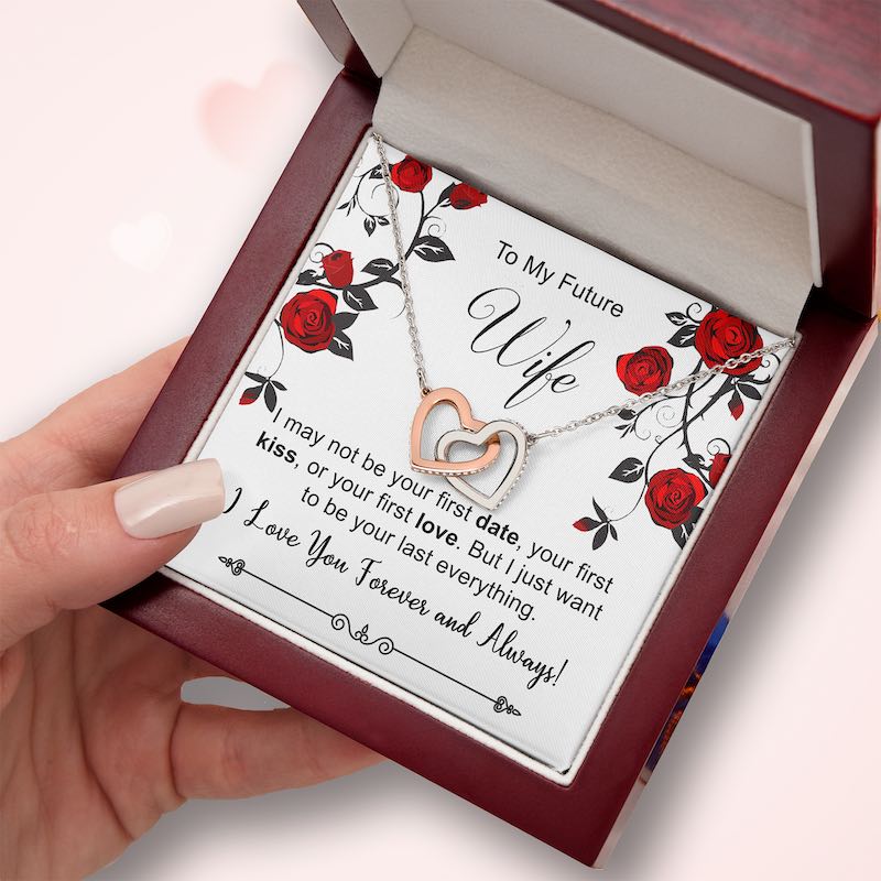 Necklace with interlocking hearts in a box with a message for 'Future Wife' on a pink background.