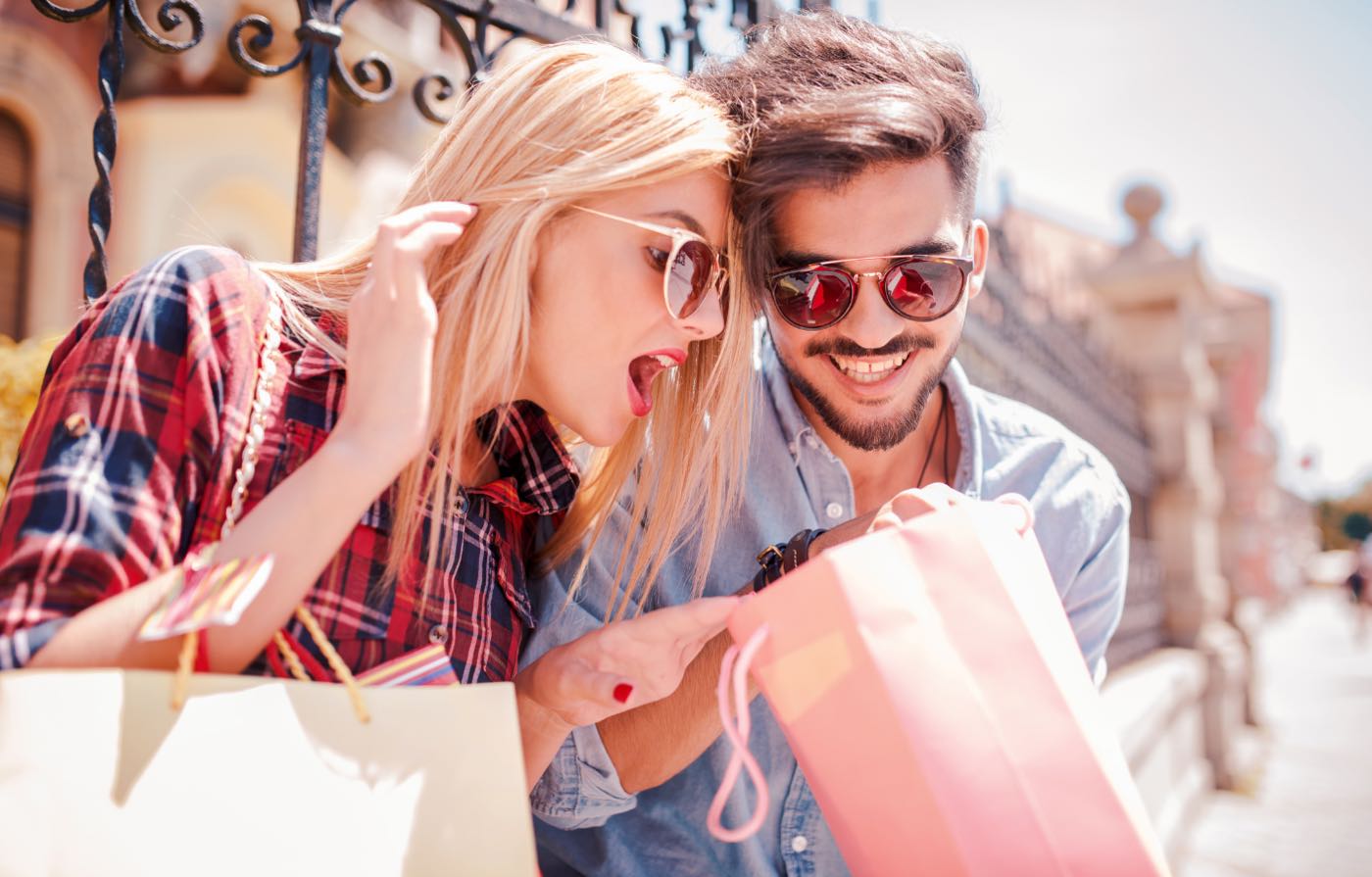 Two people with shopping bags in an urban setting