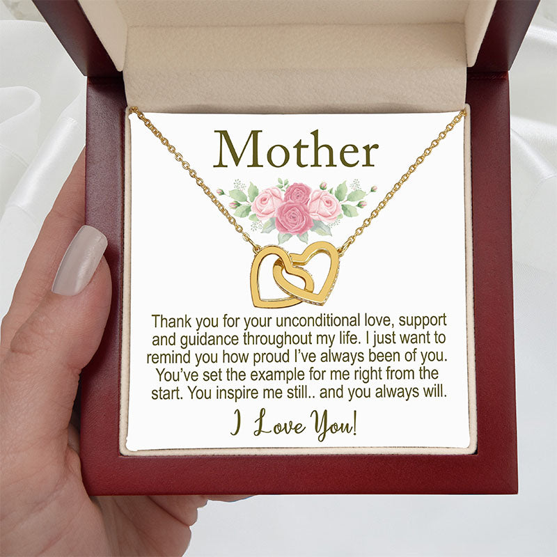 Gold necklace with interlocking hearts in a box with a card for 'Mother'.