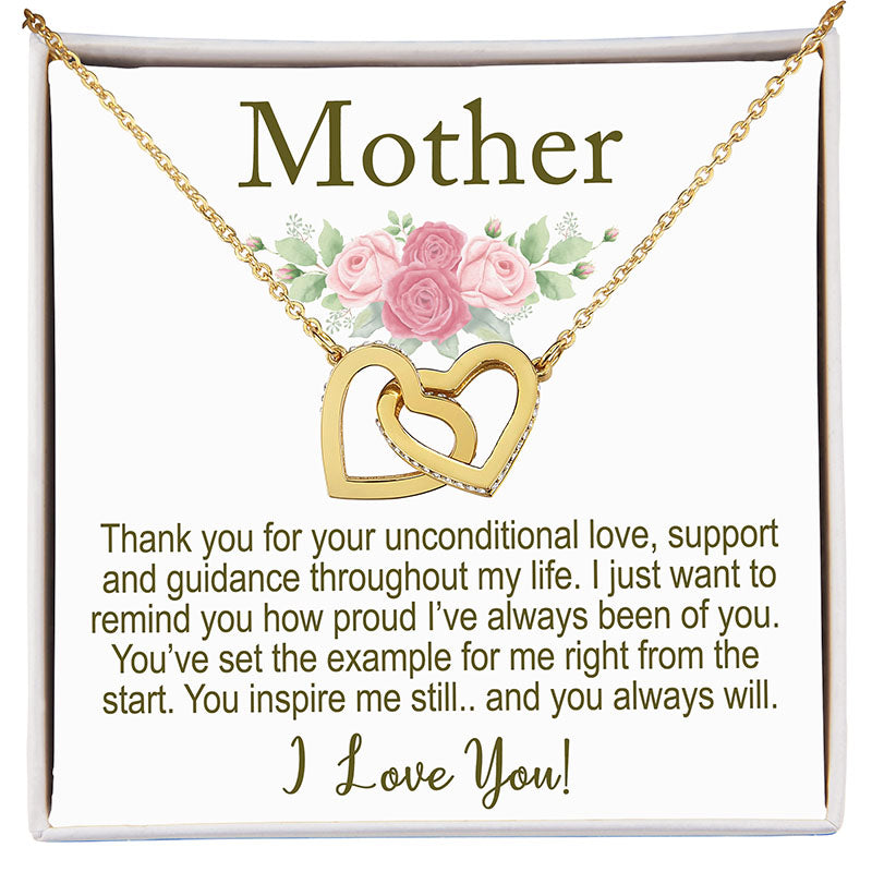 Gold necklace with interlocking hearts on a card with floral design and text.