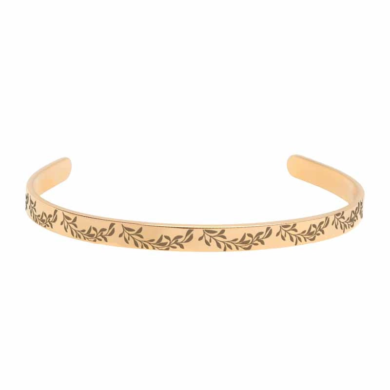 Rose-gold bracelet with leaf pattern on a white background