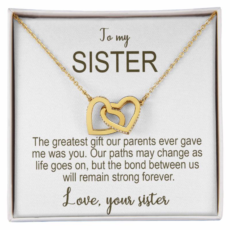 Gold necklace with interlocking hearts on a card addressed to 'my Sister' with sentimental text.