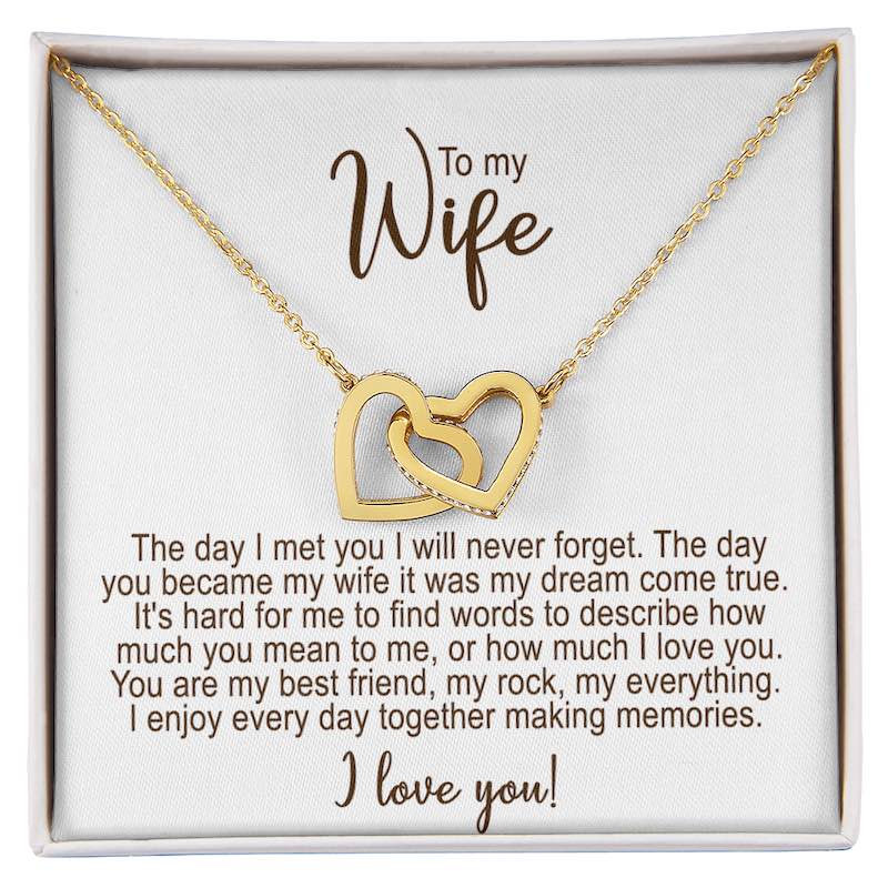 Gold necklace with interlocking hearts in a gift box with a sentimental message for a wife.