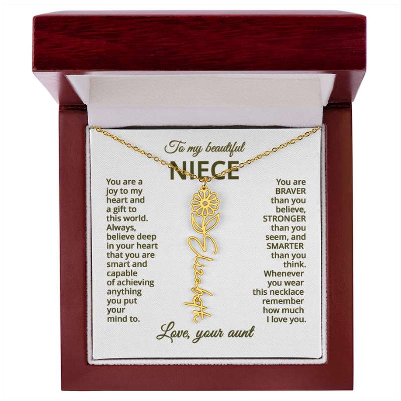 Gold necklace with a daisy flower pendant on a card with meaningful message for niece, displayed in a mahogany style box.
