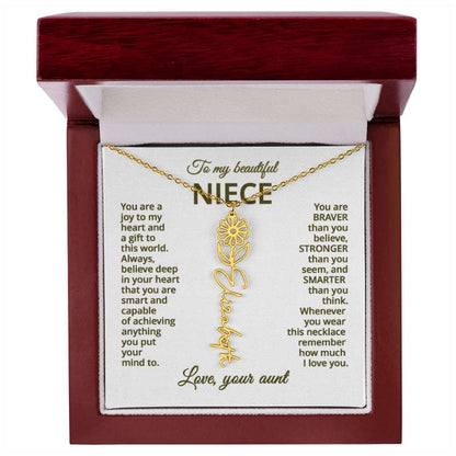 Gold necklace with a daisy flower pendant on a card with meaningful message for niece, displayed in a mahogany style box.