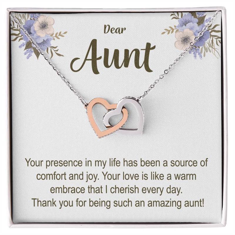 Necklace with interlocking heart pendants on a card for an aunt, featuring a heartfelt message.