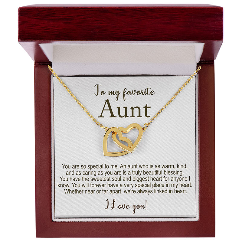 Gold necklace with interlocking hearts in a gift box with a message for an aunt.