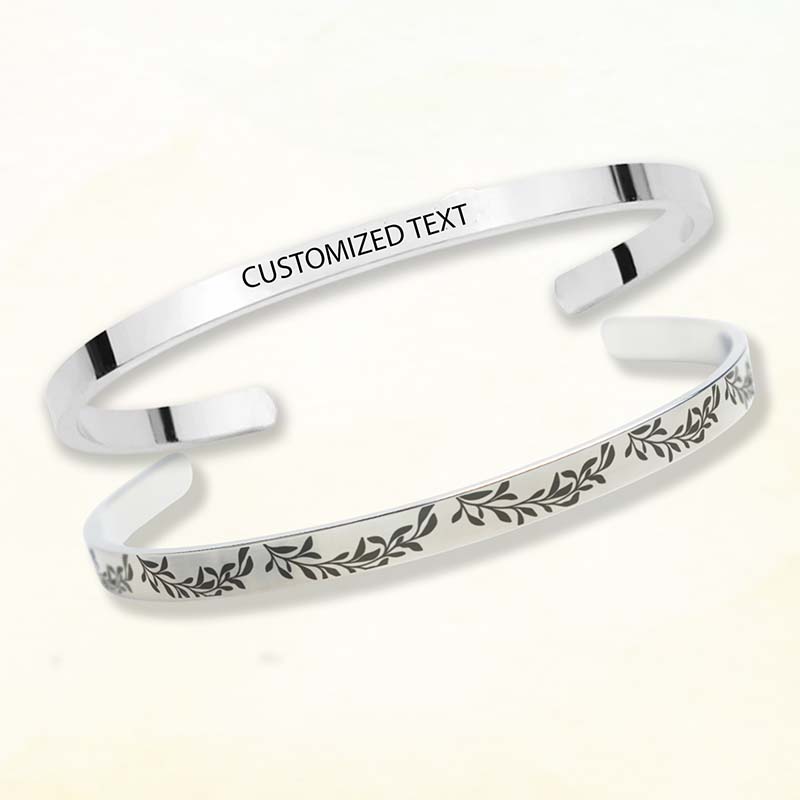 personalized bridesmaid gifts - Silver bracelet with engraved text and leaf design on a white background