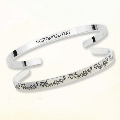 personalized bridesmaid gifts - Silver bracelet with engraved text and leaf design on a white background