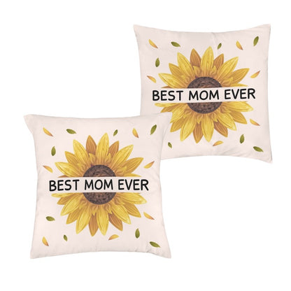 Two square off-white throw pillowcases, each featuring a large yellow sunflower graphic with bold black text reading "BEST MOM EVER" printed across the center.