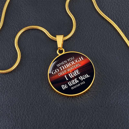 Gold necklace with a pendant featuring an Isaiah bible verse, on a dark background.