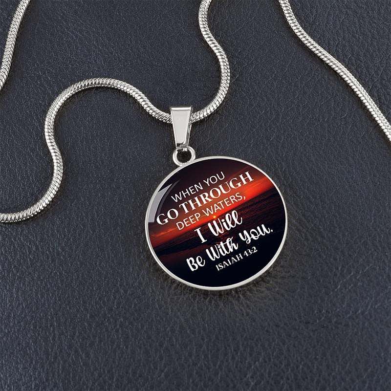 Round pendant with bible verse on a dark background