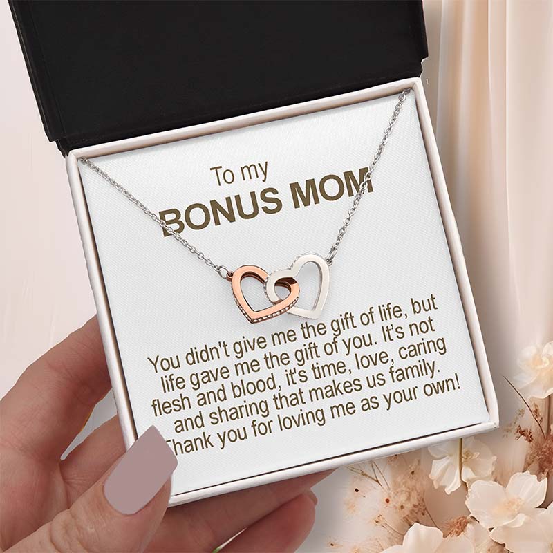 Necklace with interlocking hearts in a gift box addressed to a 'bonus mom' with a heartfelt message.
