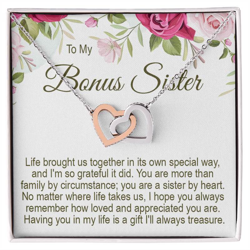 Bonus sister gifts: Interlocking rose gold and silver heart necklace presented in a gift box with a floral message card titled "To My Bonus Sister."