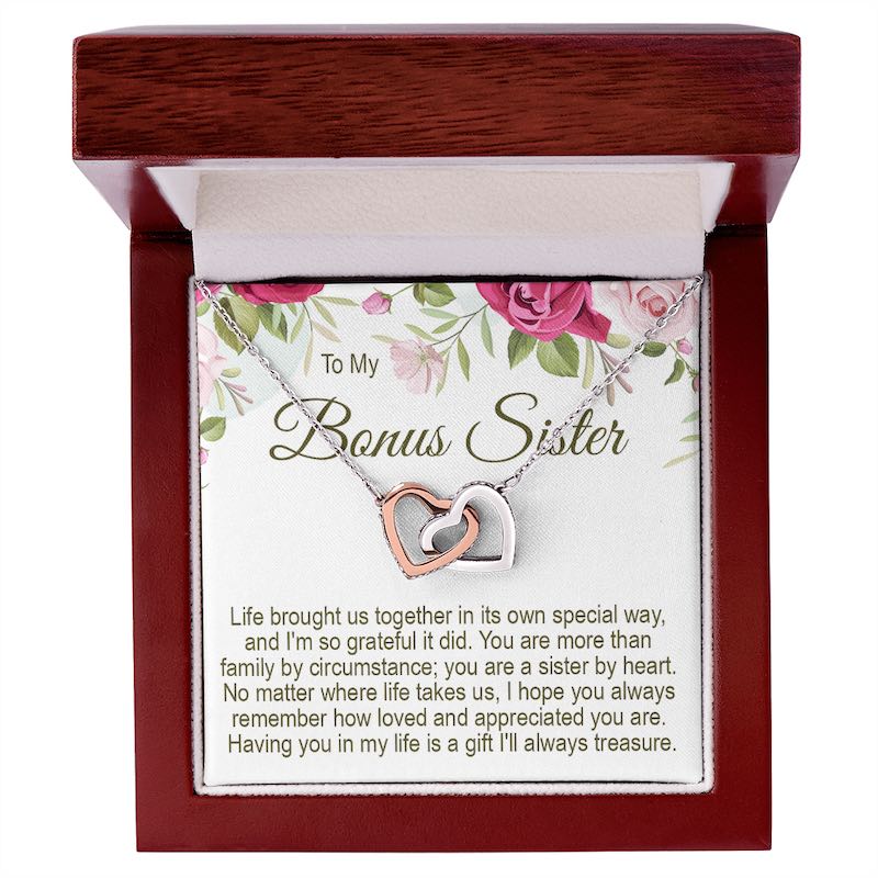 Unbiological sister gifts: To My Bonus Sister interlocking rose gold and silver heart necklace in a mahogany-style wooden gift box with a floral message card.   