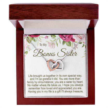 Unbiological sister gifts: To My Bonus Sister interlocking rose gold and silver heart necklace in a mahogany-style wooden gift box with a floral message card.   