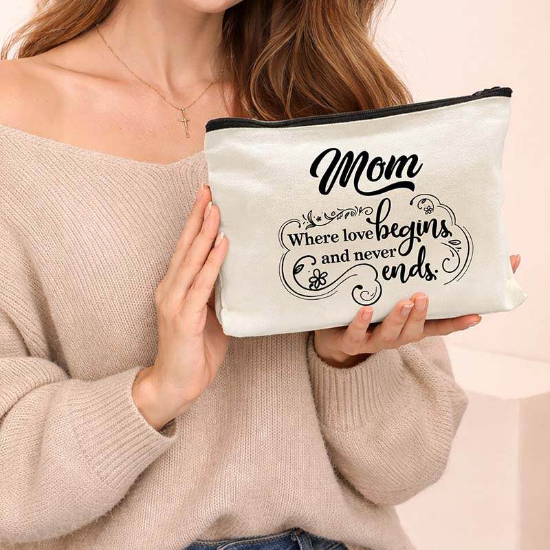 Person holding a pouch with 'Mom where love begins and never ends' text