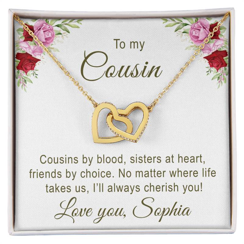 Gold necklace with interlocking hearts on a card with floral design and personalized message for cousin.