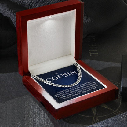 Silver Cuban link chain necklace presented in an illuminated wooden display box with a built-in LED spotlight and a dark blue "To my COUSIN" message card.   