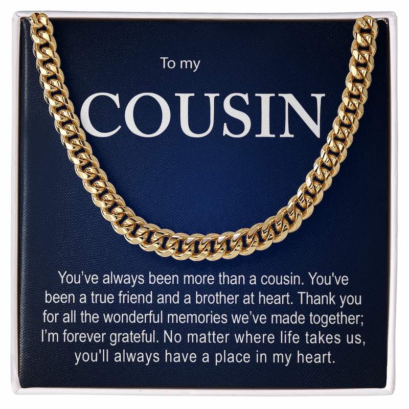 Men's gold Cuban link chain necklace presented inside a white gift box over a dark blue personalized card reading "To my COUSIN" with a heartfelt message