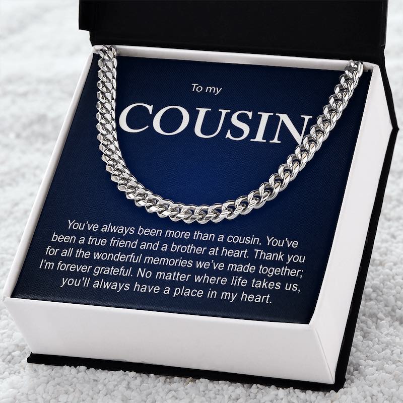 Silver Cuban link chain necklace displayed inside an open black gift box against a dark blue card reading "To my COUSIN" with a sentimental message.   