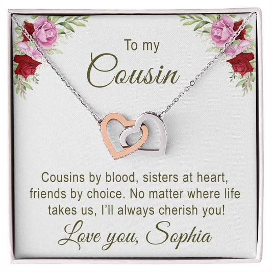 Necklace with interlocking heart pendants on a white background with floral design and text card for a cousin.