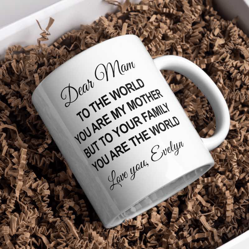 White mug with a message on a bed of brown crinkle paper