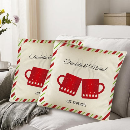 Two decorative pillows with red mugs and personalized text on a couch.