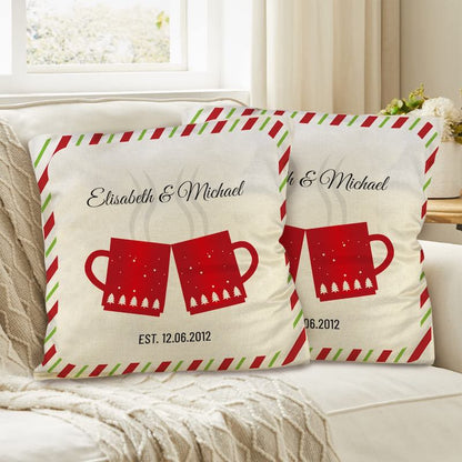 Two decorative pillows with red mugs and personalized text on a couch.