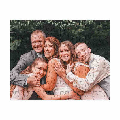 Completed custom photo jigsaw puzzle featuring a smiling family of five hugging outdoors.
