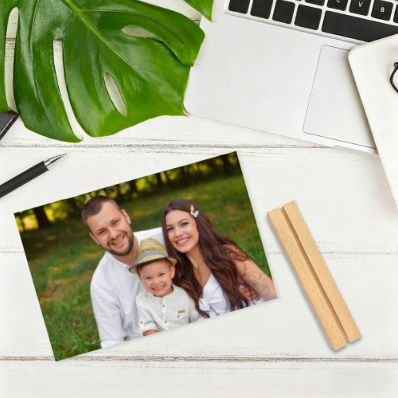 Customized acrylic photo frame displaying a family photo, with a wooden base placed beside it