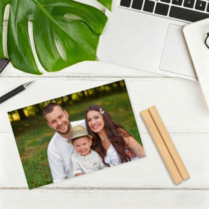 Customized acrylic photo frame displaying a family photo, with a wooden base placed beside it