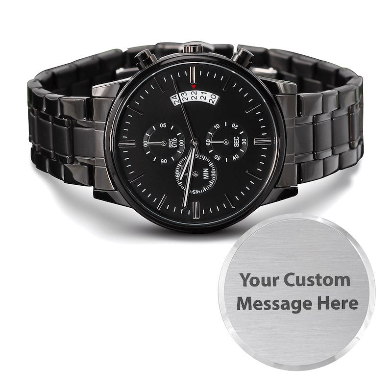 A black stainless steel analog watch with a multi-dial design and a day/date window, shown alongside a circular silver customizable badge that reads 'Your Custom Message Here'.