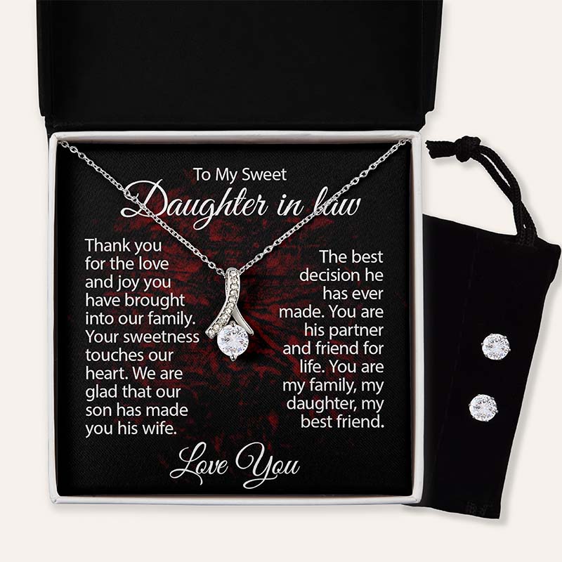 Silver ribbon pendant necklace displayed in a gift box with a heartfelt daughter-in-law message card and matching cubic zirconia stud earrings in a black velvet pouch.