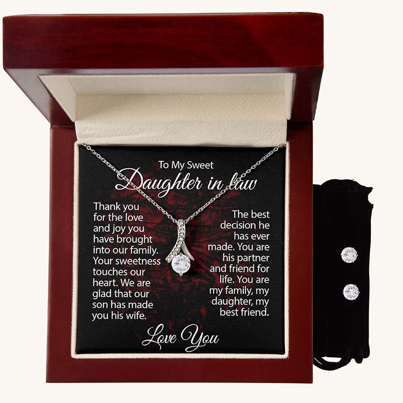 Silver ribbon pendant necklace displayed in a luxury mahogany gift box with a heartfelt daughter-in-law message card and matching cubic zirconia stud earrings in a black velvet pouch.