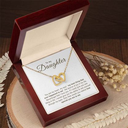 Daughter Gift Gold Hearts: gold necklace in a gift box with a message card on a wooden surface.