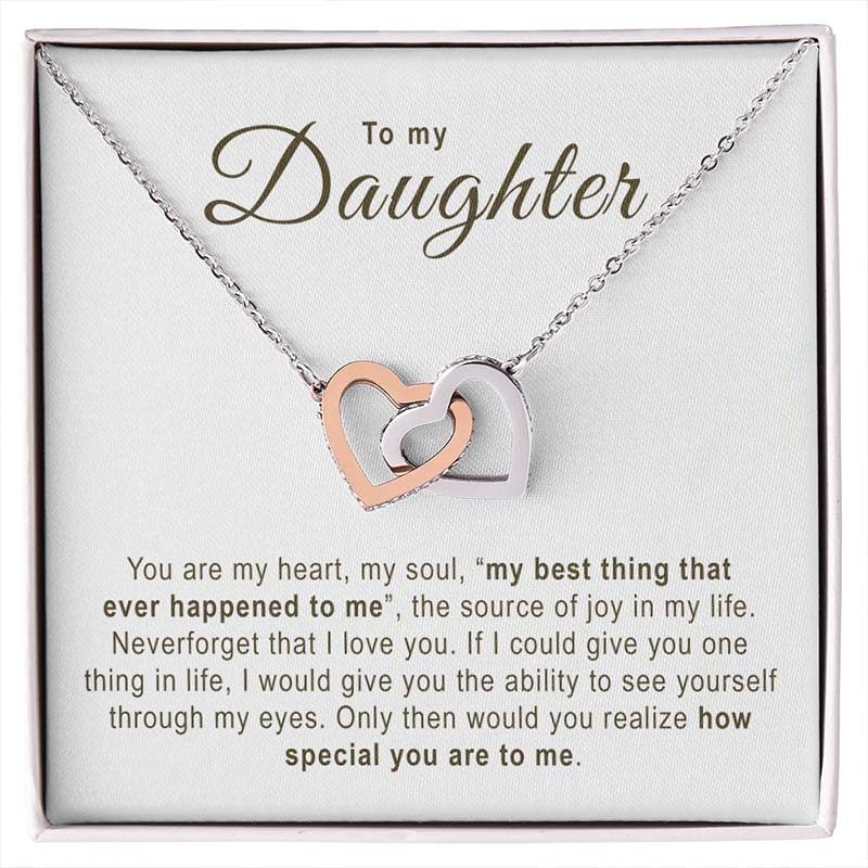 Necklace with interlocking heart pendants on a card addressed to a daughter, with sentimental text.