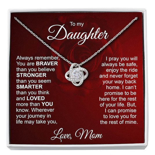 A silver necklace with a heart-shaped pendant set with small clear stones, presented on a red gift card inside a white box. The card has sentimental text addressed 'To my Daughter' and 'Love, Mom'.