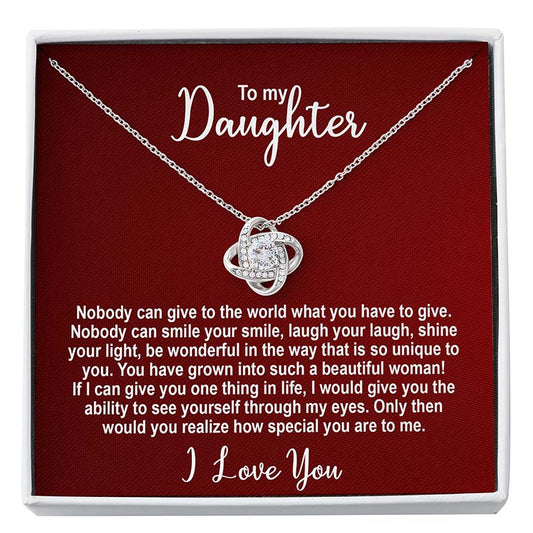 Silver knot necklace in a box with personalized message for a daughter on a red card.