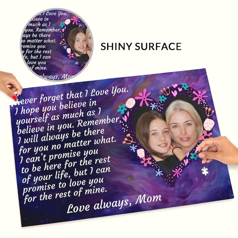 Hands placing a piece onto a custom mother-daughter photo puzzle, with a top inset labeled "SHINY SURFACE" highlighting the glossy finish of the printed design.   