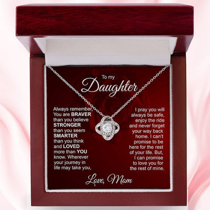 Silver love knot necklace displayed in a mahogany-style luxury gift box with an inspirational message card dedicated "To my Daughter, Love, Mom."   