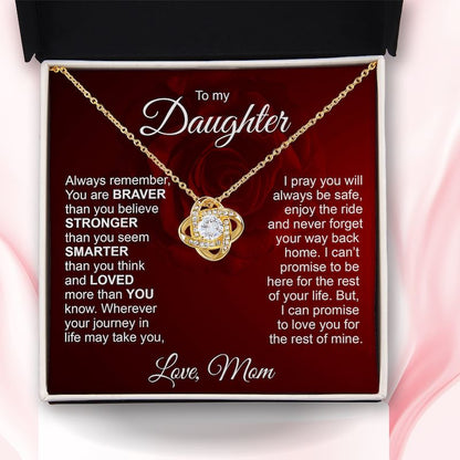 A gold necklace with a heart-shaped pendant and clear rhinestones, presented inside a black/white gift box with a red insert card addressed 'To my Daughter' with sentimental text.