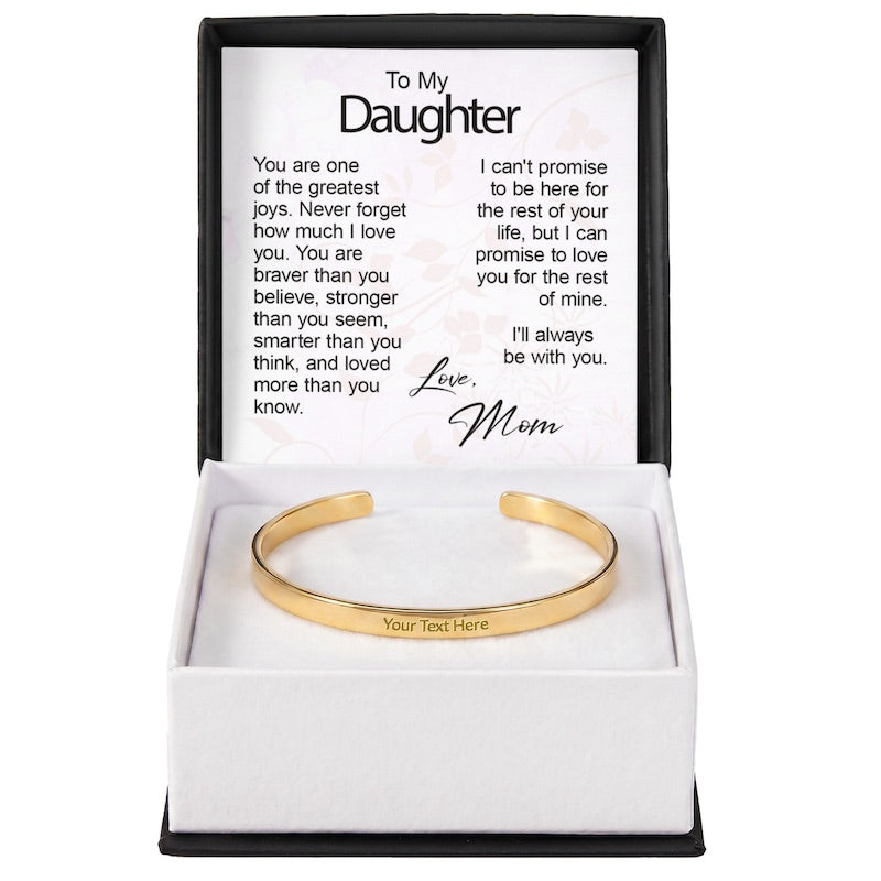 Gold custom-engraved cuff bracelet with "Your Text Here" sample engraving, displayed in a gift box with a "To My Daughter" sentiment card.
