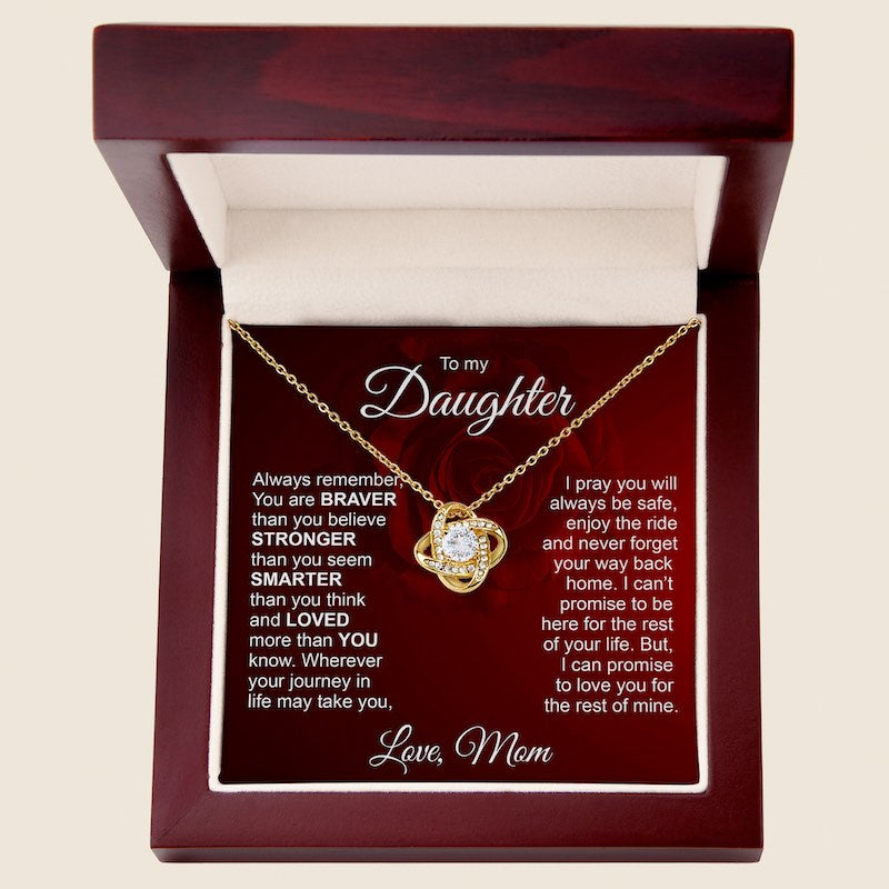 Gold love knot necklace displayed in a mahogany-style luxury gift box with an inspirational message card dedicated "To my Daughter, Love, Mom.
