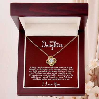 Gold knot necklace in a mahogany box with personalized message for a daughter on a red card.
