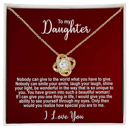 Gold knot necklace in a standard box with personalized message for a daughter on a red card.