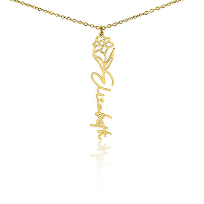 Gold flower birth name necklace with December birth flower narcissus pendant and custom 'Elizabeth' engraving on a white background