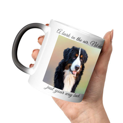 Mug with a dog design and text held by a hand on a white background
