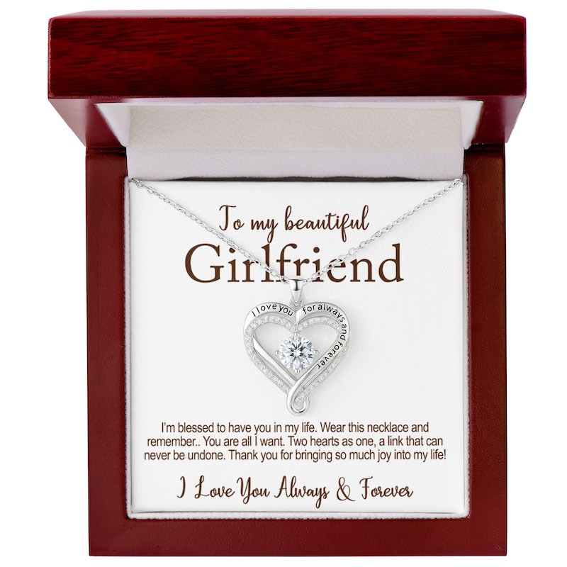 Necklace with heart design in a wooden box with a message for a girlfriend.